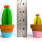 Cute single 3D paper blooming cacti in teracotta pots with ruler showing the heights ranging from 3-4 inches.