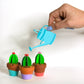 Trio of cute single 3D paper cacti in teracotta pots with blue paper watering can.