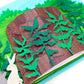 Image showing details of cut paper illustration of bunnies around a tree stump in bushes.