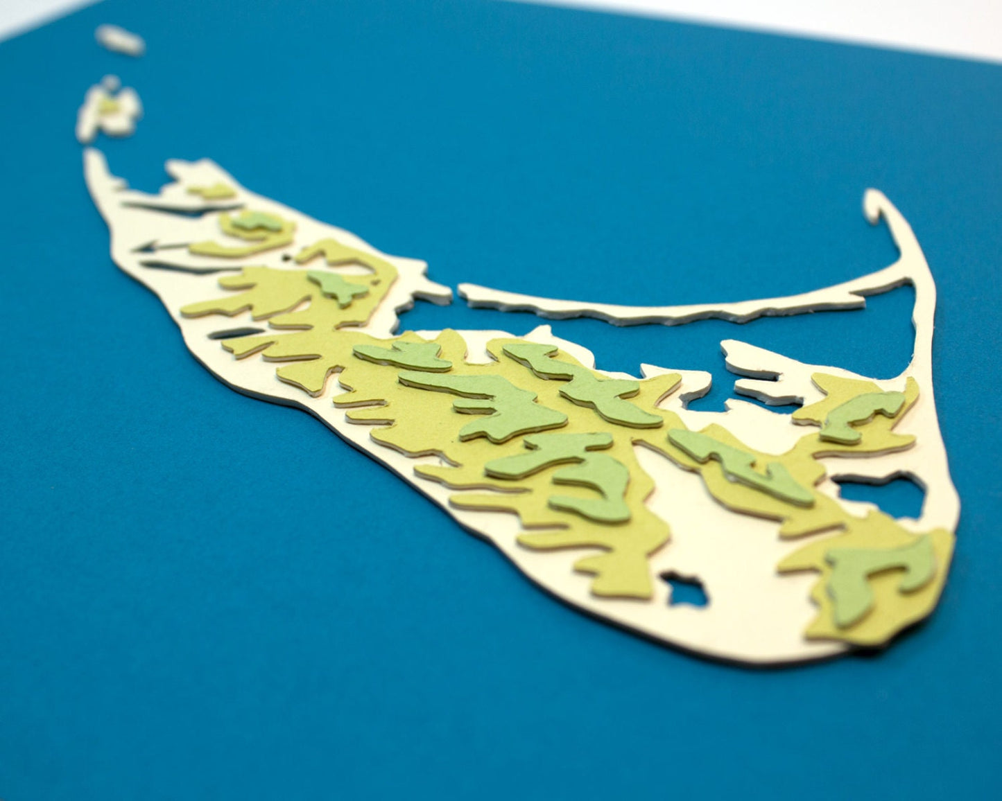 Framed original cut paper topographical map of Nantucket Island.