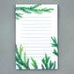 Notepad with cut paper illustration of tree branches at the top and bottom.