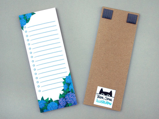 Cute notepad with cut paper illustration of blue hydrangea flowers.