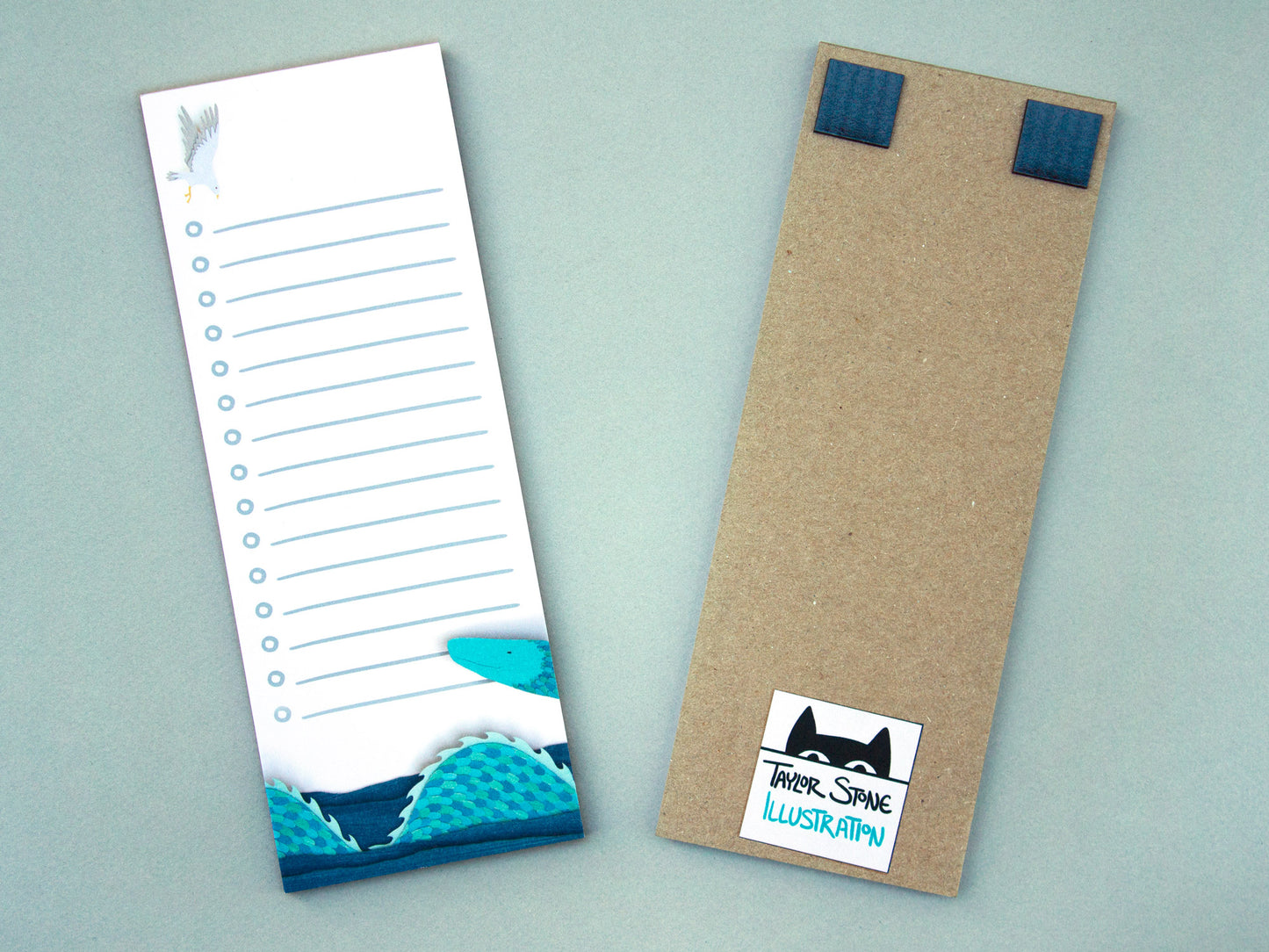Cute notepad with cut paper illustration of blue sea serpent monster at bottom and sea gull at top.