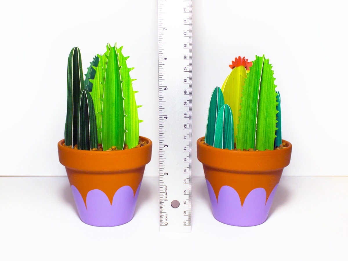 Cute bunch of green 3D paper cacti in terracotta pots with ruler showing height of about 6.5" inches.