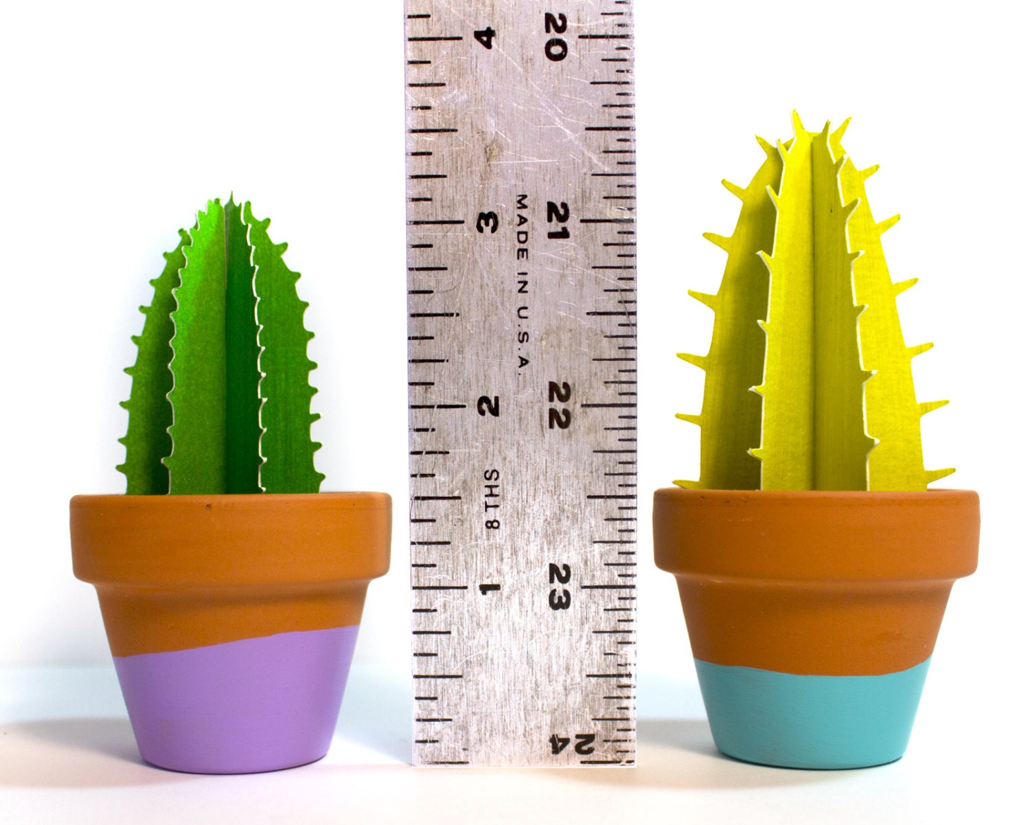 Cute single spiky 3D paper cacti in terracotta pots with a ruler showing height of about 3.5" inches.