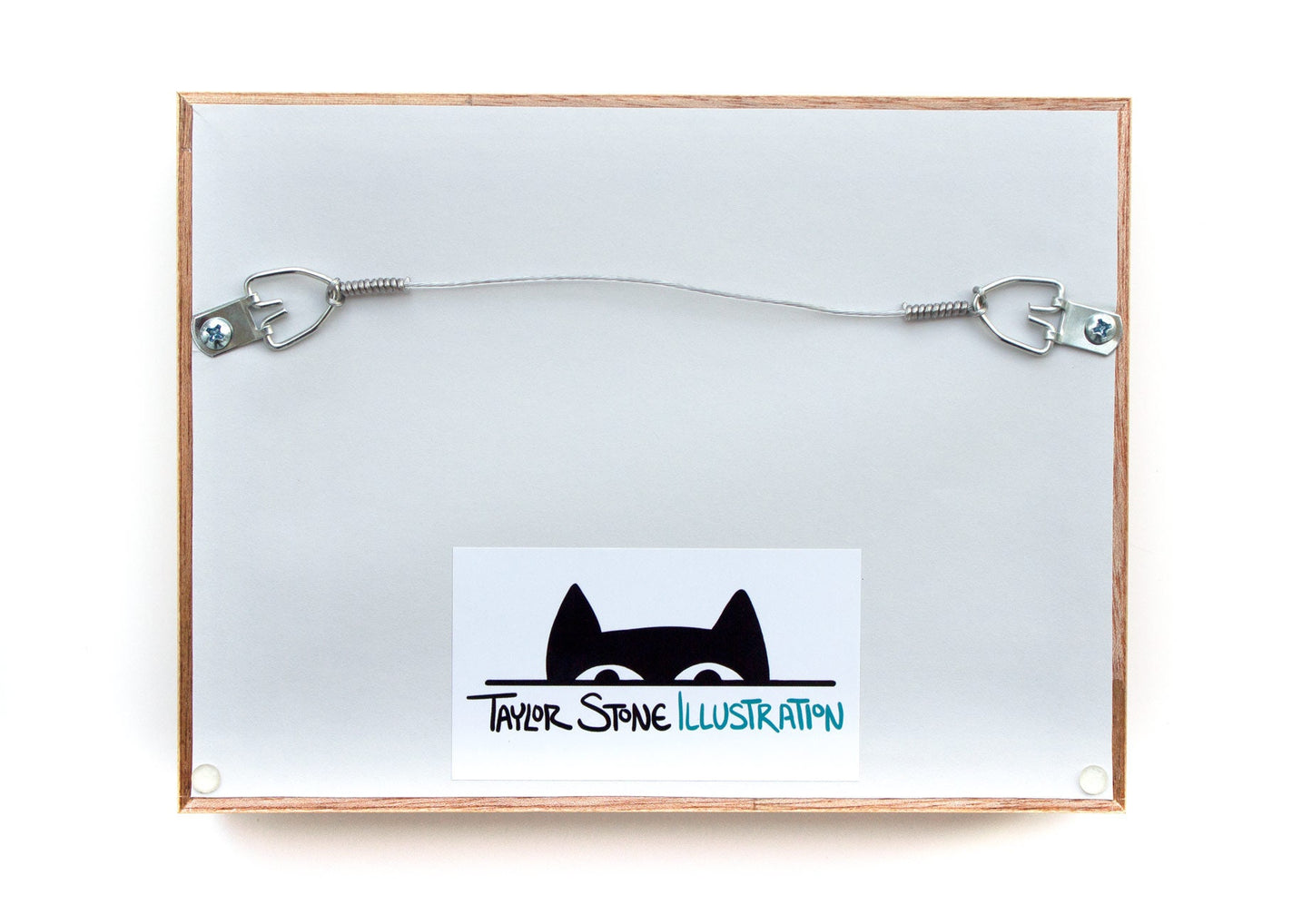 Back of Taylor Stone Illustration frame for cut paper illustrations with cat logo and horizontal wire hook for hanging.