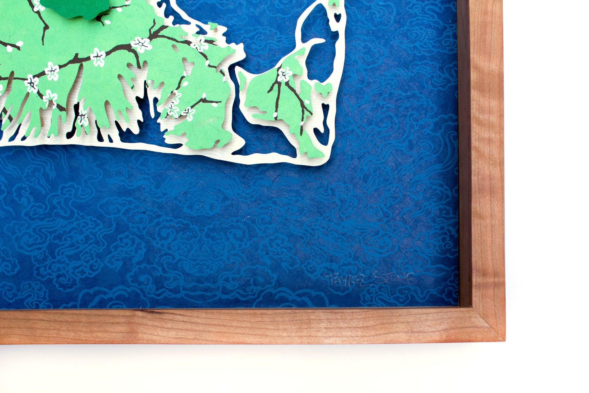 Framed original cut paper topographical map of Martha's Vineyard Island against beautiful blue Japanese paper background.
