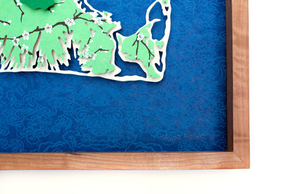 Framed original cut paper topographical map of Martha's Vineyard Island against beautiful blue Japanese paper background.