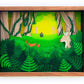 Framed cut paper illustration of cute forrest scene with deer, fox, and hiker.