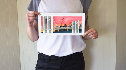 Archival print of cut paper illustration of the Brooklyn Bridge with Sunset.