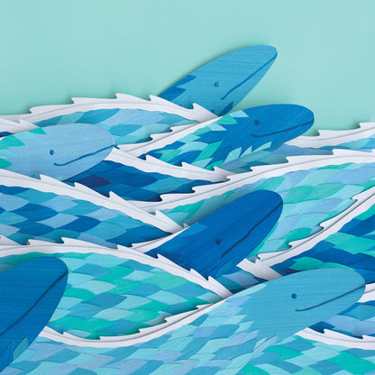 Archival print of cut paper illustration of several cute blue sea serpents swimming.