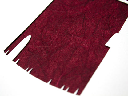 Framed simple deep red and white cut paper illustration of the Gay Head lighthouse in Aquinnah, on Martha's Vineyard.