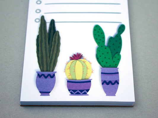 Cute notepad with cacti in purple pots at the bottom