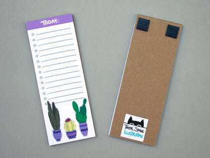 Cute notepad with cacti in purple pots at the bottom