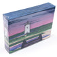 Cute jigsaw puzzle of cut paper illustration of the Edgartown Light House on Martha's Vineyard at sunset.