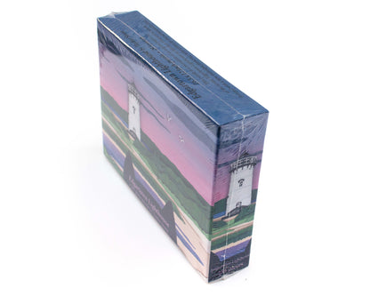 Cute jigsaw puzzle of cut paper illustration of the Edgartown Light House on Martha's Vineyard at sunset.