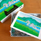 Cute jigsaw puzzle of cut paper illustration of Farm Pond in Oak Bluffs, on Martha's Vineyard with Nessie and her baby.
